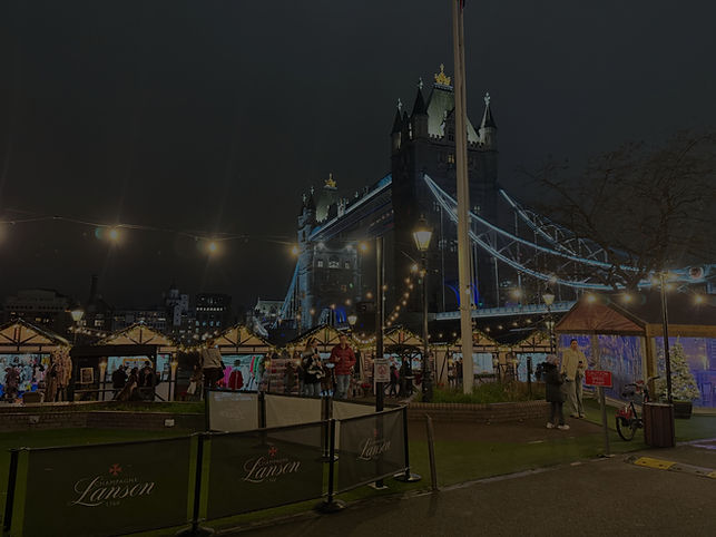 Atmospheric heritage-inspired outdoor Christmas market with warm glowing lights and traditional wooden cabins.