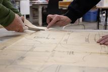 A person pointing at a sewing pattern