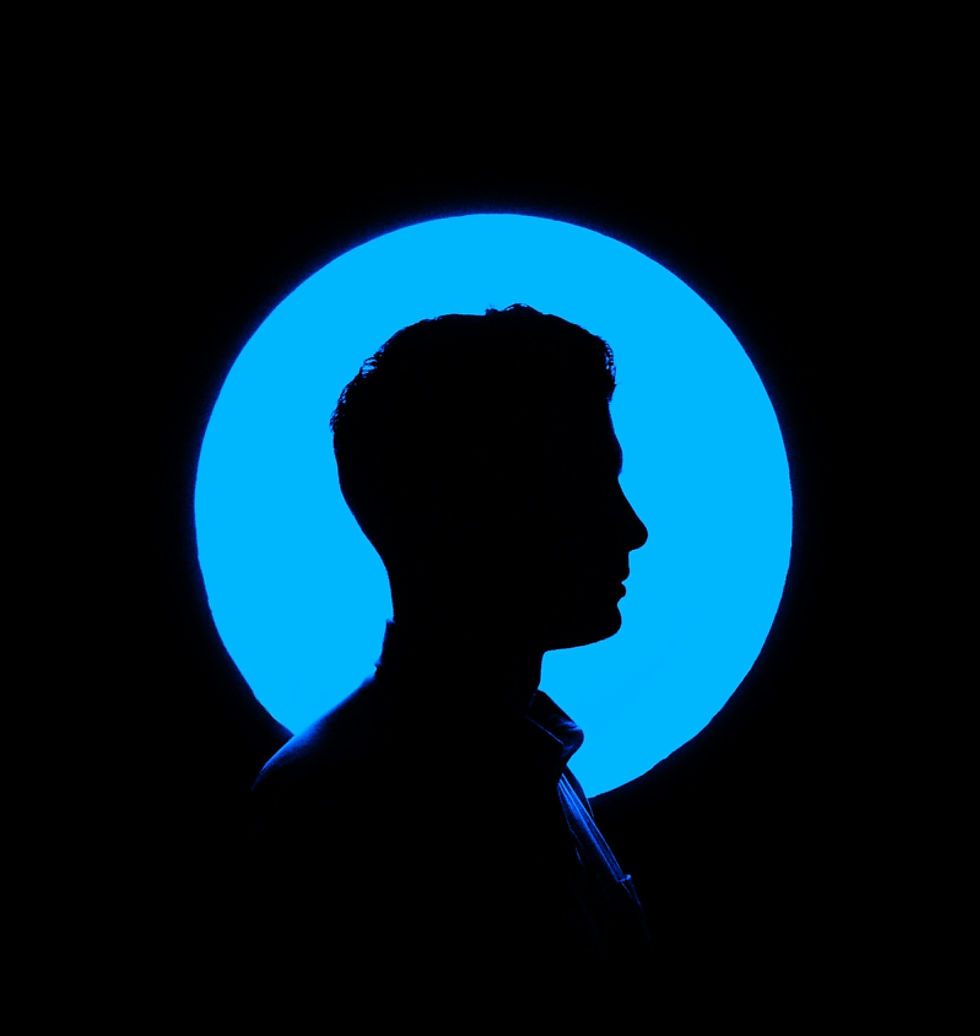 side profile of a male with blue circular background
