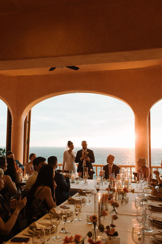 Couple giving wedding speech, sunset