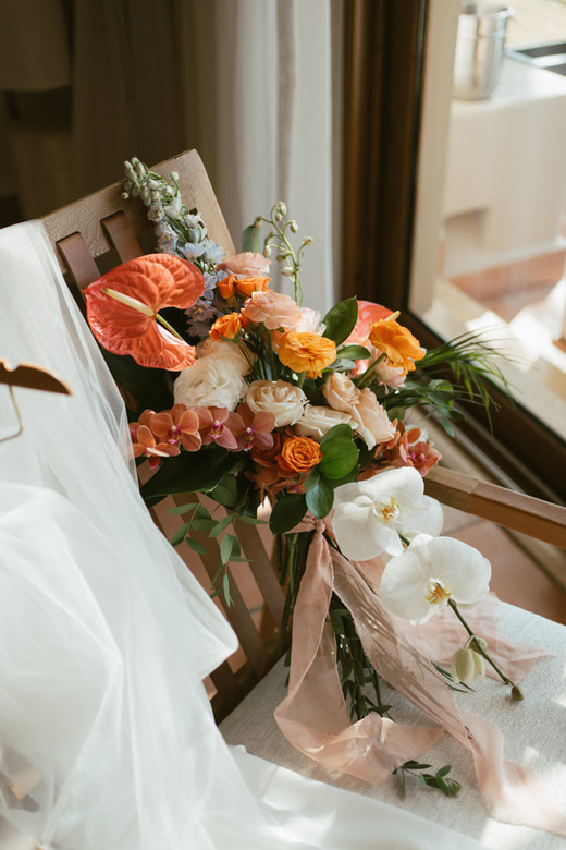 Vibrant wedding bouquet: orange, pink, and white flowers
