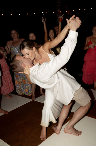 Couple kissing at WEDDINGS reception