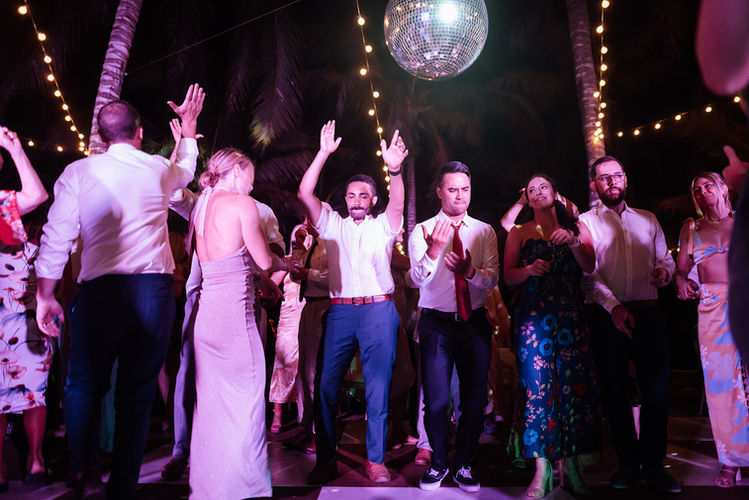 Wedding guests dance joyfully under disco ball