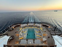 Luxury infinity pool on Explora Journeys cruise at sunset.