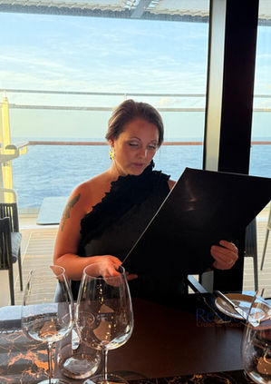 Woman reading a menu at an Explora Journeys restaurant.