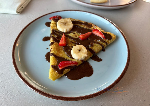 Crepe with chocolate, banana, and strawberries