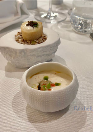 Gourmet appetizers served in textured white bowls