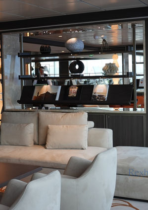 Modern lounge area with cream sofas and shelving unit