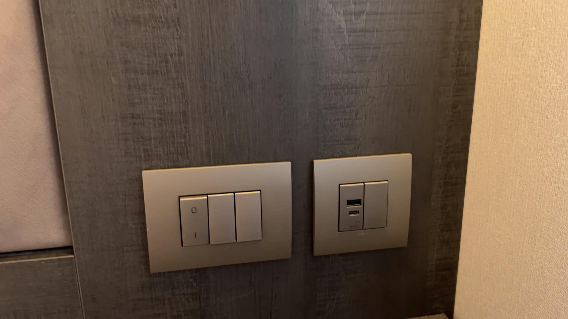 Bedside light switches and USB ports in Explora III suite
