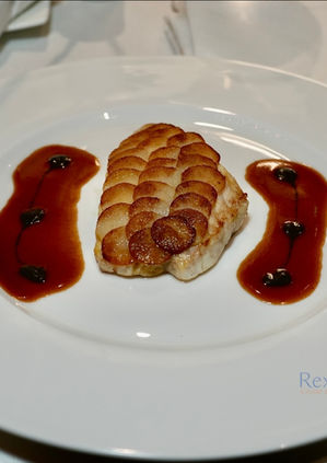 Potato-scaled fish fillet with red wine reduction