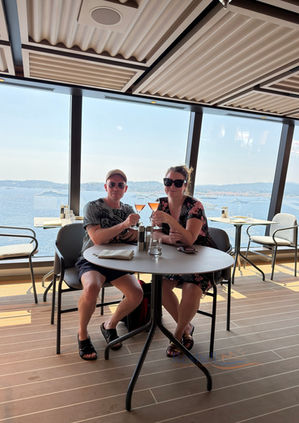 Couple toasting drinks at an Explora Journeys restaurant