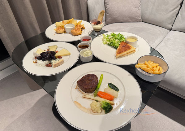 Explora Journeys in-suite dining with steak and sides.