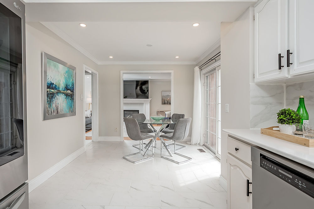 Modern kitchen and dining area with glass table