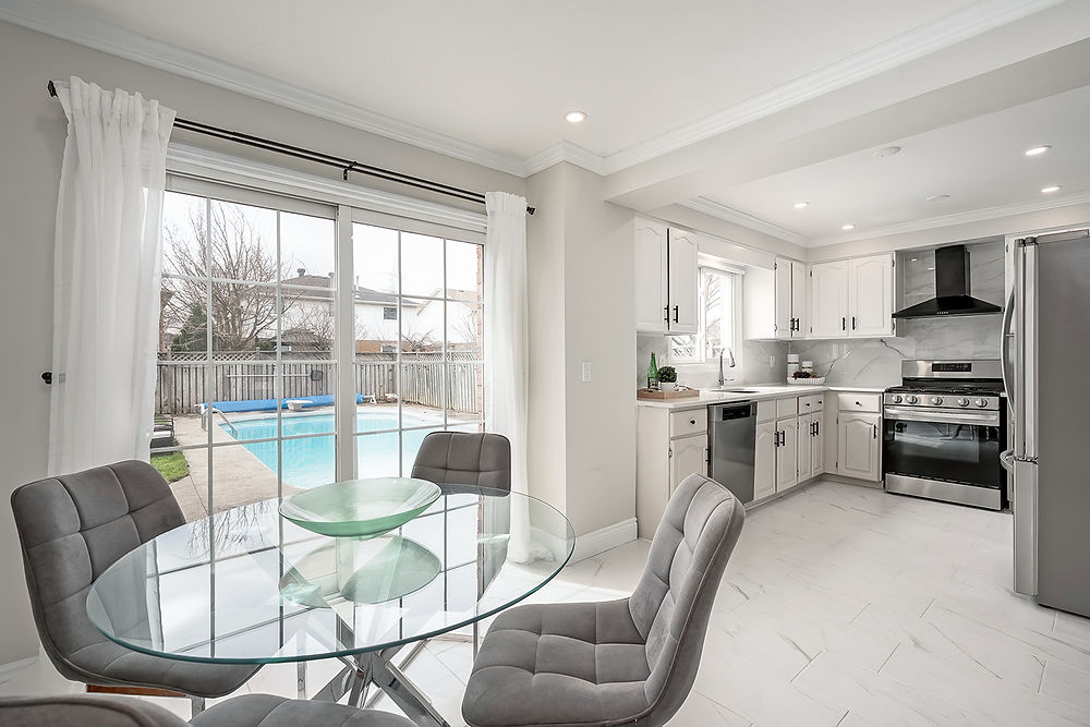 Modern kitchen and dining area with pool view