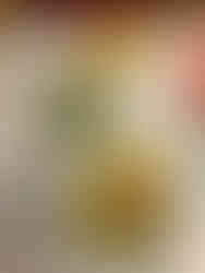 Two plates of steak frites, one with steak, creamy sauce, and french fries, and the other with green beans.