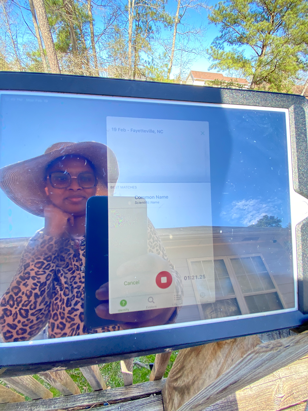 A selfie reflection of LaTasha using the Merlin Bird ID app