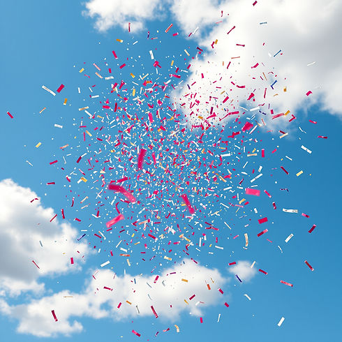 Create an explosion of confetti over a blue sky with a few clouds.jpg