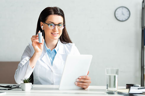 cheerful-doctor-showing-pills-to-patient-on-online-2022-04-14-20-07-14-utc.jpg