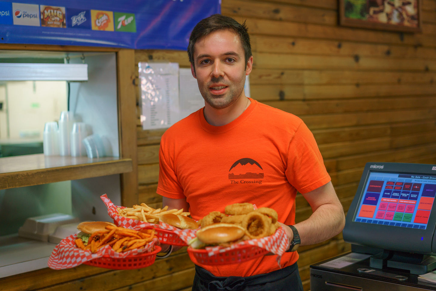 server delivering hot food at The Crossing Cafe
