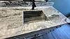 sloped sink on marble vanity