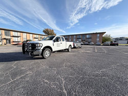 TAKERS white F-250 impound towing gray Nissan Altima