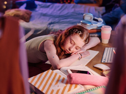 Teenage girl asleep at her desk