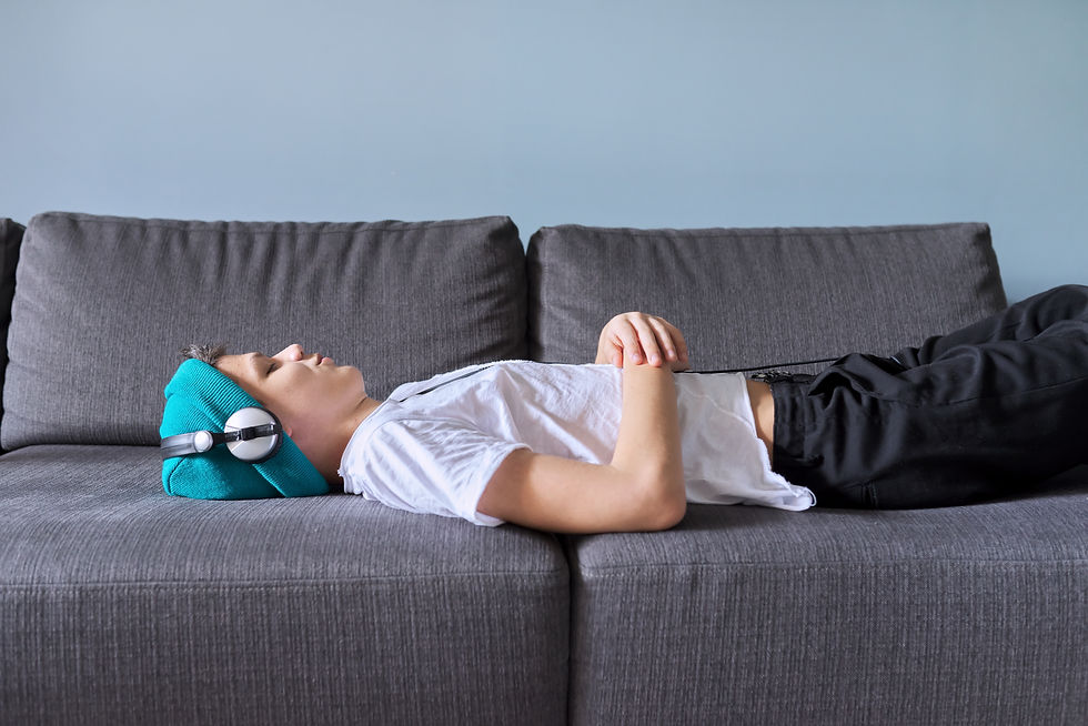 A teenager asleep on the sofa