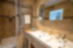 Master bedroom ensuite with double sinks, WC and shower area.