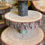 Thumbnail: Four  tiered rustic wooden log wedding cake cup stand with large base and carved