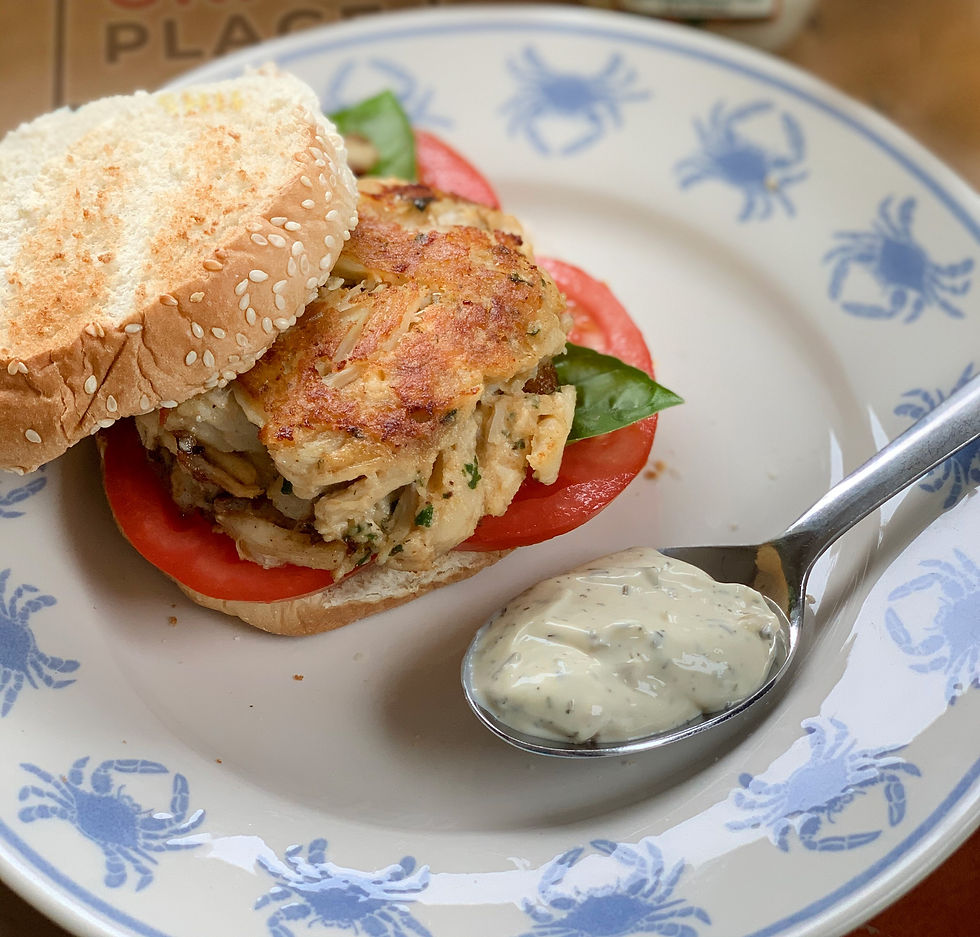 A Maryland crab cake with a spoon of homemade tartar sauce