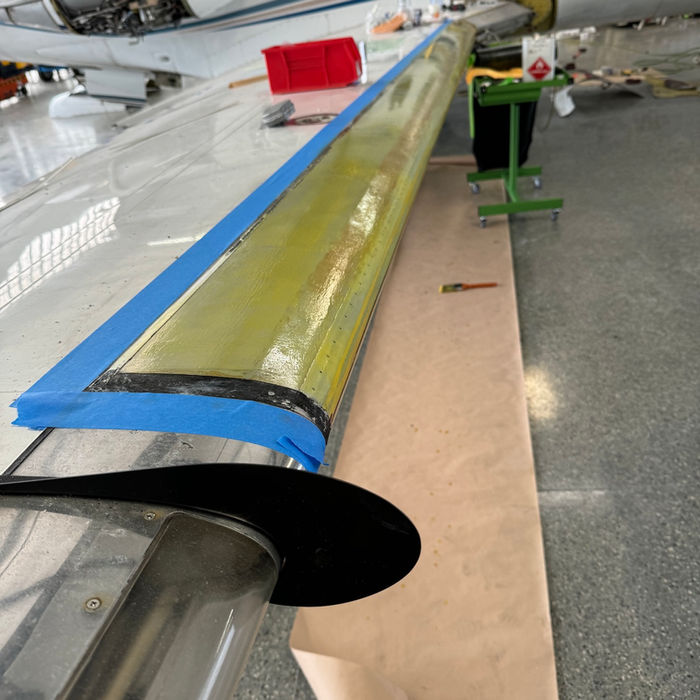 Jet aircraft undergoing maintenance in a hangar