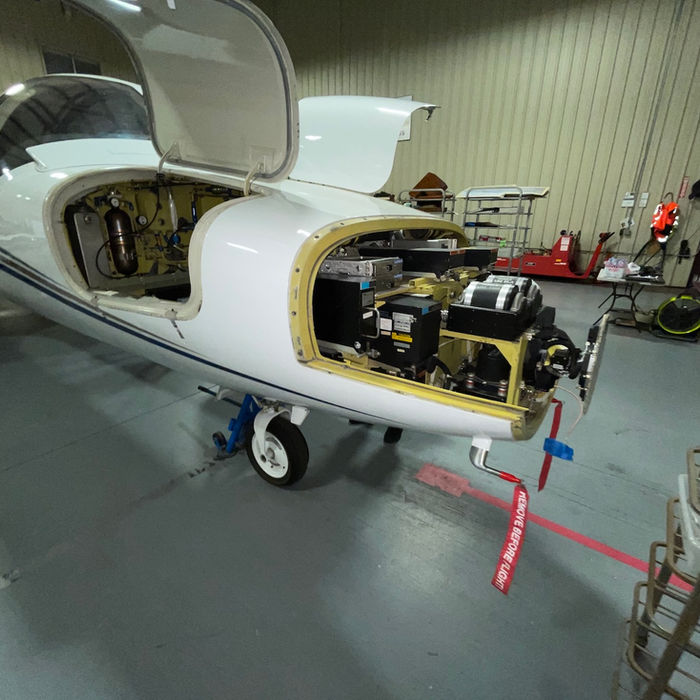 Jet aircraft undergoing maintenance in a hangar