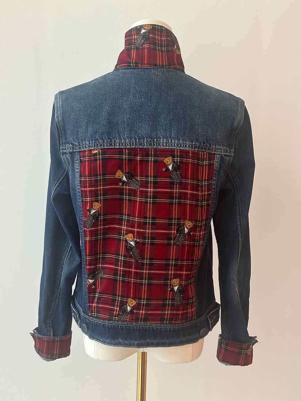 Thumbnail: The back view of a jean jacket with a Ralph Lauren scarf sewn on the back