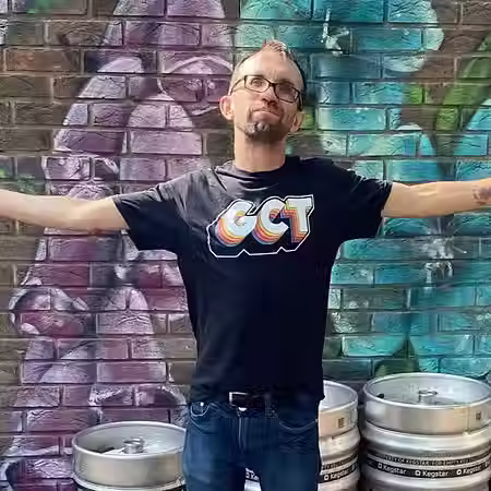 Ed standing outside with his arms open