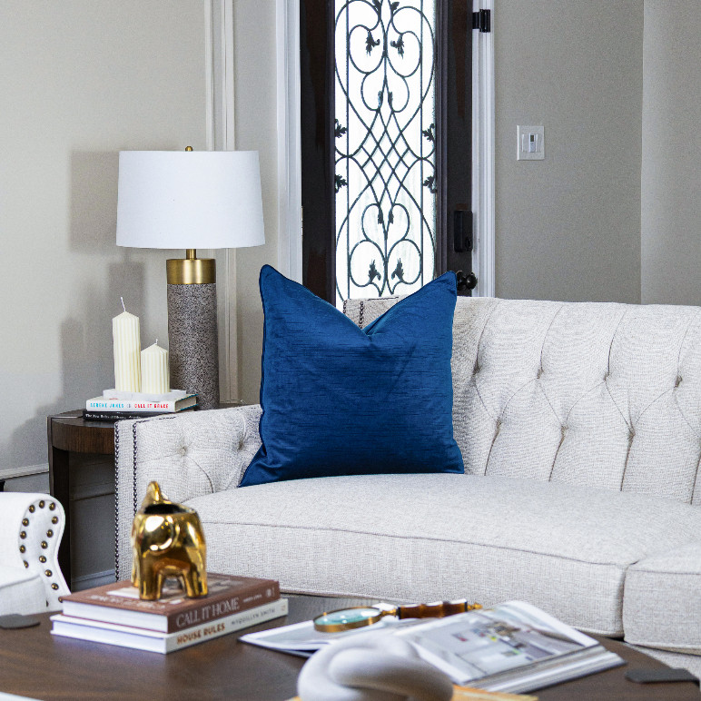 Blue velvet pillow on white sofa