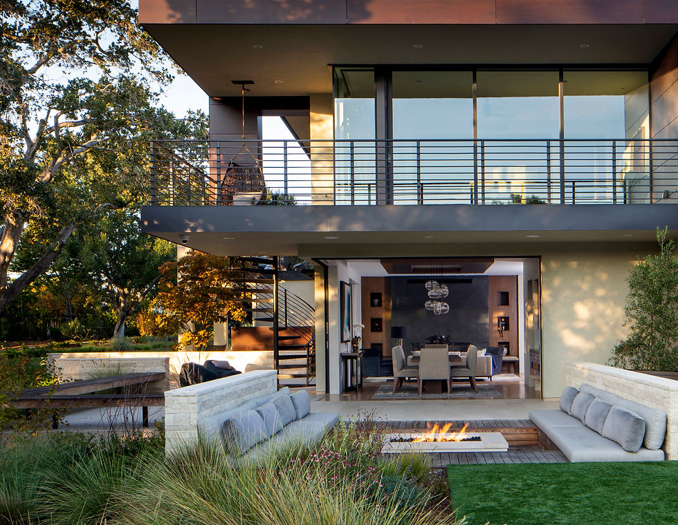 Photograph of a luxurious backyard entertainment area with firepit