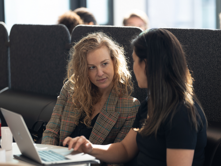 two women sitting and talking
