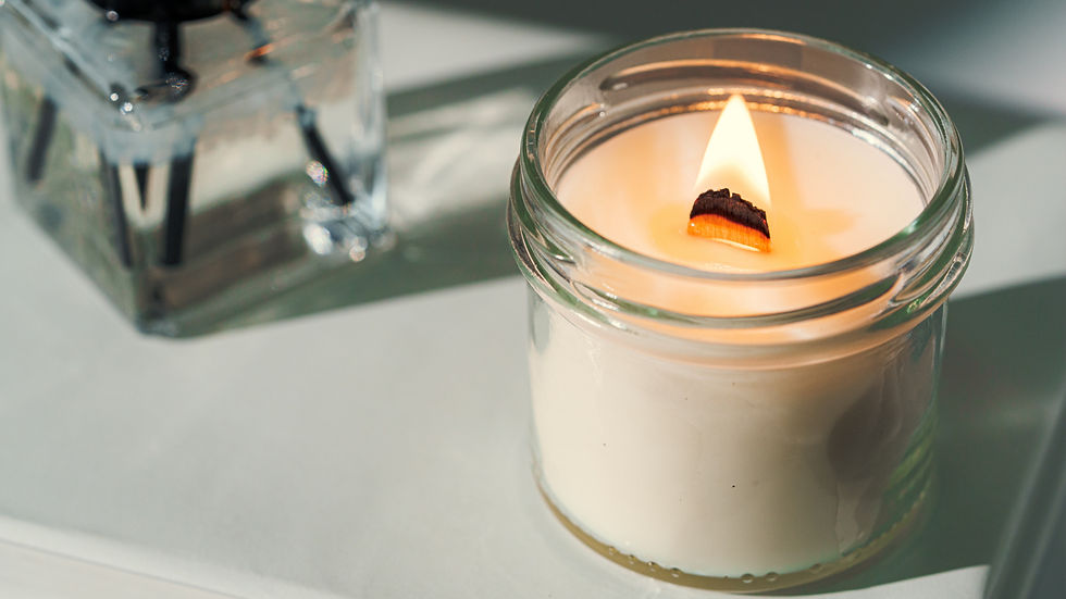 a white wooden wick candle burning genly