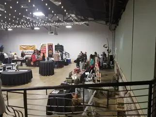Image of tables and chairs set up for a formal event in the event space at 1520 Clay