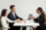 A picture showcasing an interview of one female candidate with two interviewers on left.