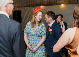 Couple laughing at each other at a wedding, A glorious Farm Wedding in Aldbourne, Wiltshire.