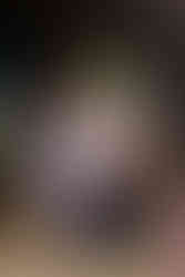 Children interact with a decorated tractor wheel with text, flowers, and greenery.