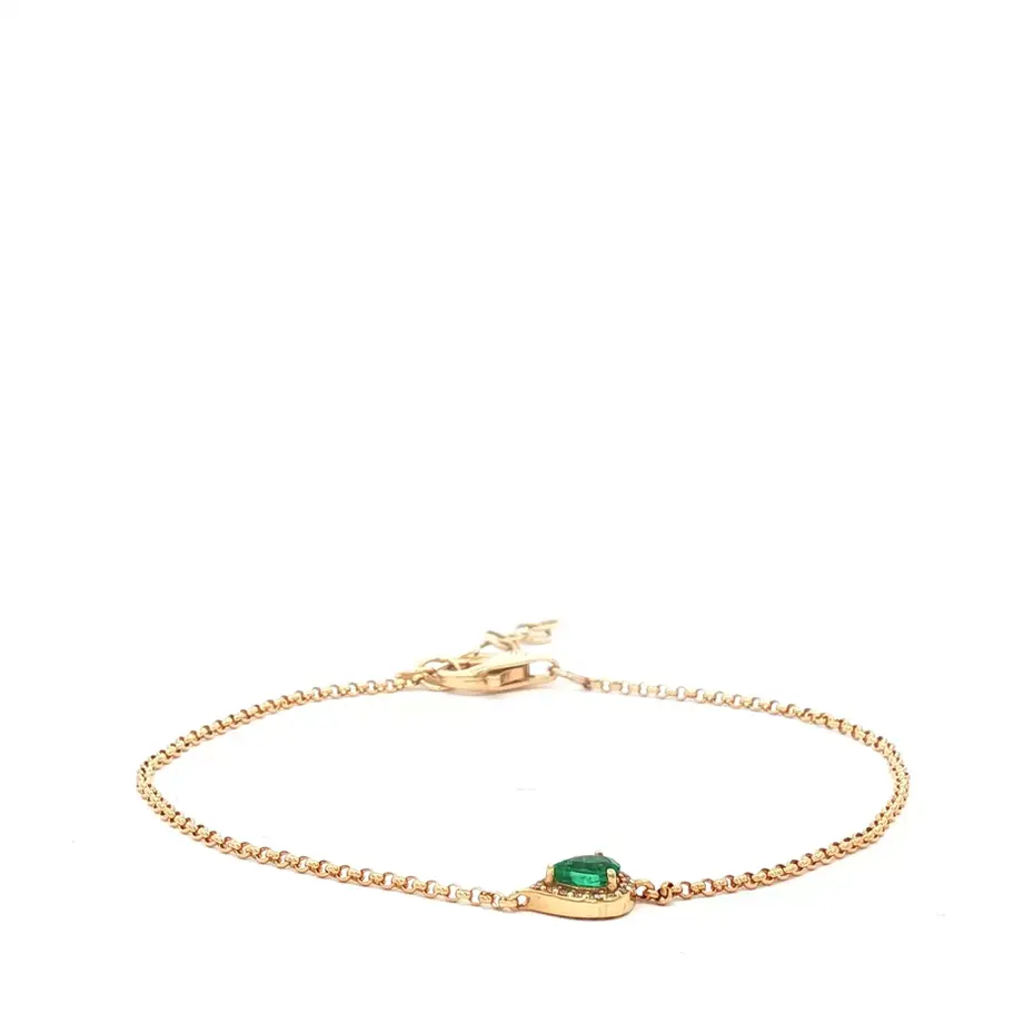 Brazalete dorado con una piedra preciosa verde brillante. Boué Joyeros.