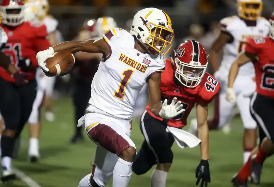 Westerville North's Daniel Johnson looks for running room while evading Westerville South'