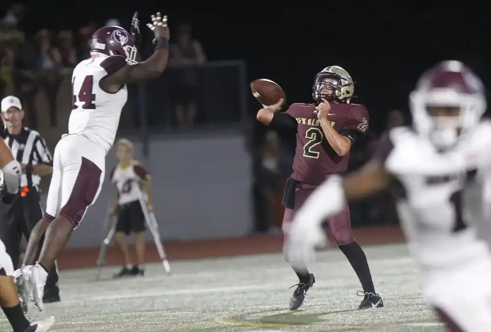 Canal Winchester's Davonte Dourtney tries to block the pass from New Albany's Luka Garver
