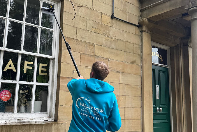 window cleaner cleaning a cafe in Waterfoot, Rossendale United Kingdom