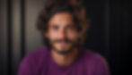 vecteezy_ai-generated-a-confident-smiling-man-with-a-beard-and-curly_40575493 1