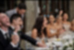 The MC Jordan shares a hilarious moment with the couple and guests, filling the room with laughter at the dinner table.