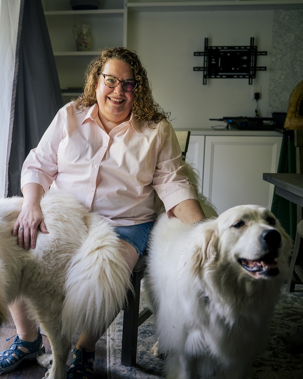 Carrie Killingsworth, 53, sits with her dogs Penelope and Noreen at her home in Hilliard, Ohio.