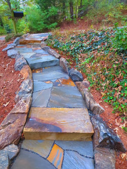 Front yard walkway with Crab Orchard sandstone steps, flagstone landings and flanking boulders